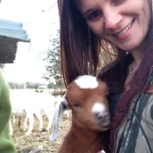 Me with our neighbors newborn goats.